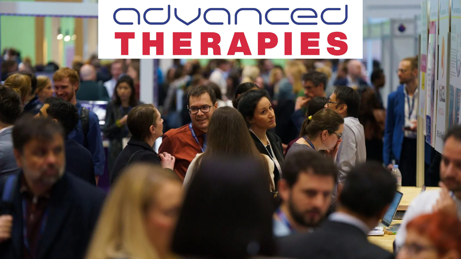 A crowd of people interact at a conference under a sign reading advanced THERAPIES in blue and red text.